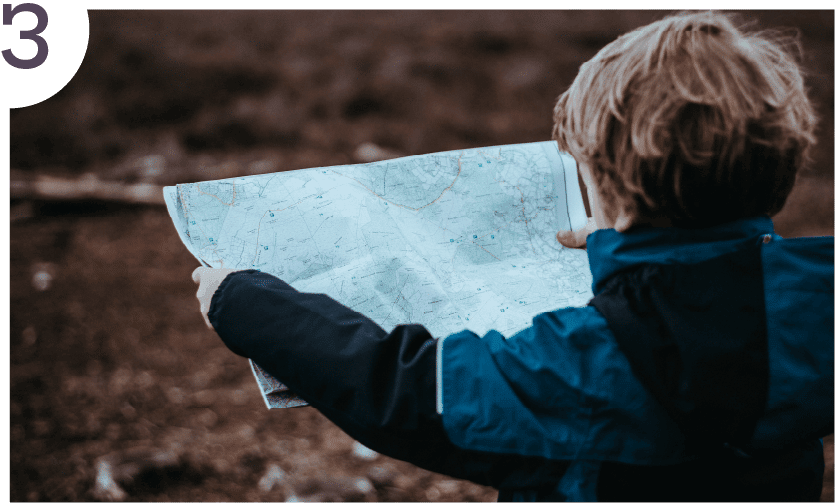 A child, bundled up in a fall jacket holds a map. They're practicing orienteering in nature - seeing how things are connected. This image illustrates the third step - to connect.